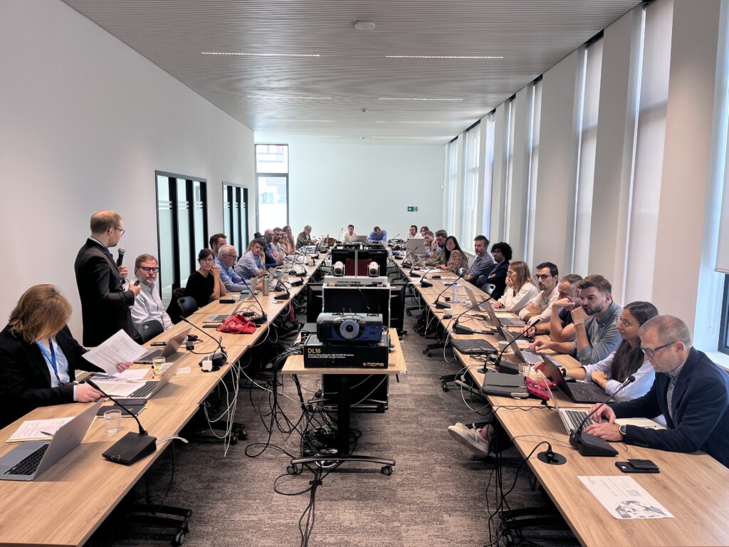 Participants discussing regulatory frameworks for electricity sharing and energy communities during an Interreg Europe policy workshop in Namur.